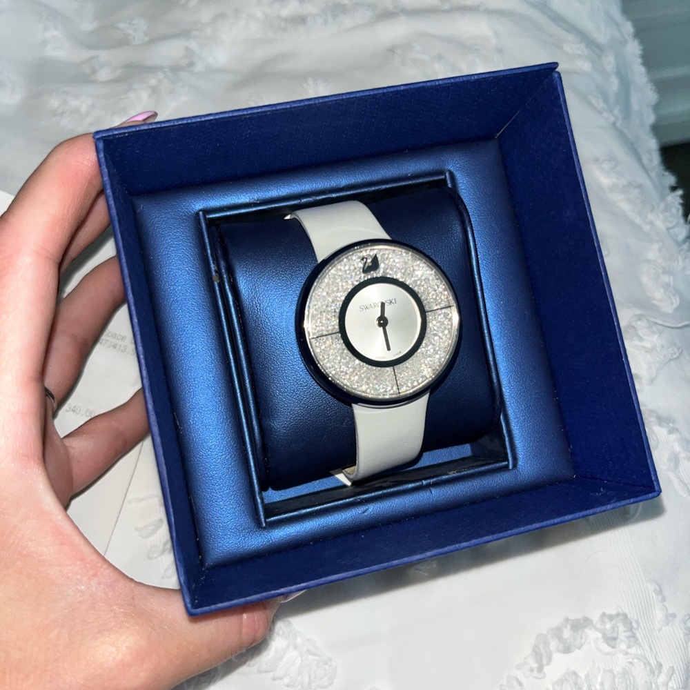 Gently used swarowski watch with white leather straps